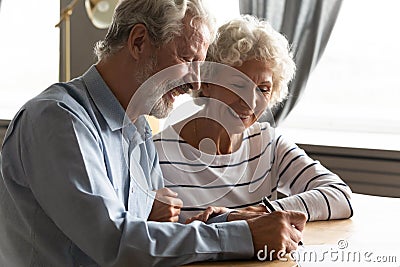 Satisfied senior couple signing agreement buying medical health insurance Stock Photo