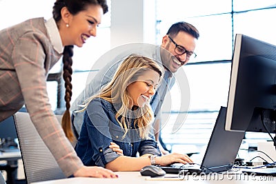 Satisfied team going over their finished project before important meeting. Stock Photo