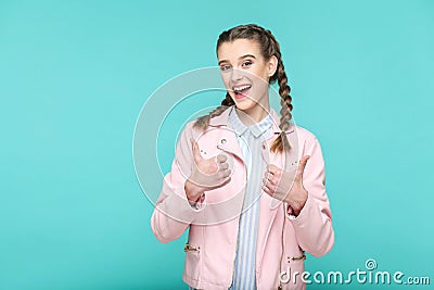 Satisfied thumbs up. portrait of beautiful cute girl standing wi Stock Photo