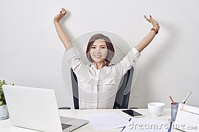 Satisfied woman relaxing with hands behind her head. Happy smiling employee after finish work, reading good news, break at work, Stock Photo