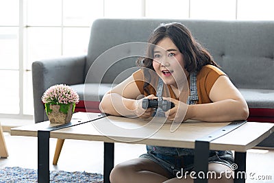 Satisfy chubby woman play video games at homechubby woman play video games at home Stock Photo