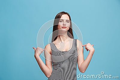 The satisfy woman standing on the blue background. Stock Photo