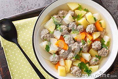 Satisfying sodd is Norway national dish which usually consists of mutton, meatballs, carrots, and potatoes served in a clear, Stock Photo