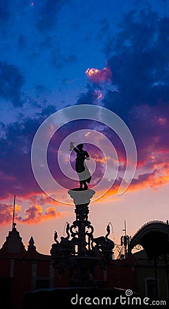 Satue and kiosk in backlight, colorful sunset scene with sky and clouds Stock Photo