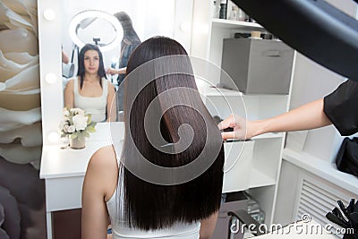 Saturated healthy shiny hair after keratin recovery. The concept of recovery structure. Stock Photo