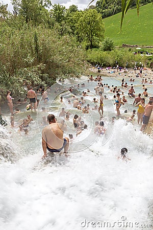 People bathing in natural spa of the hot Mill waterfalls of cascate dele Mulino. Grosseto, Tuscany, Editorial Stock Photo