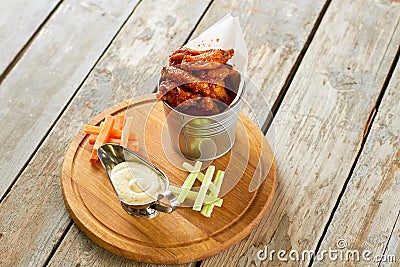 Sauce boat and bucket with fried chicken parts. Stock Photo