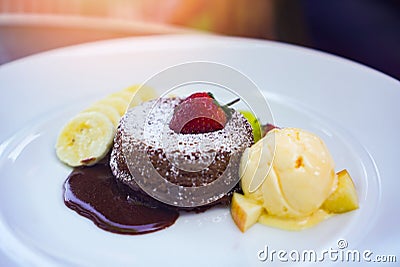 Sauce chocolate cake strawberry ice cream vanilla fruit with apple banana on the white plate delicious dessert Stock Photo