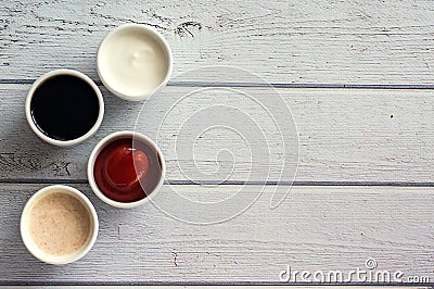 Sauces ketchup, mustard, mayonnaise, sour cream, soy sauce in clay bowls on wooden white background Stock Photo