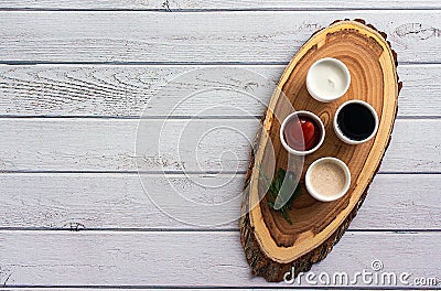 Sauces ketchup, mustard, mayonnaise, sour cream, soy sauce in clay bowls on wooden white background Stock Photo