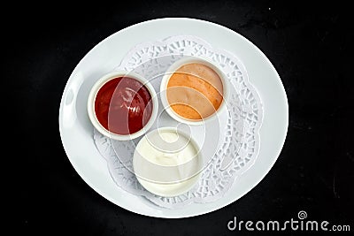 Sauces on a plate, ketchup, mayonnaise and mustard Stock Photo