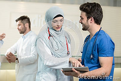 Saudi arab doctors working with a tablet. Stock Photo