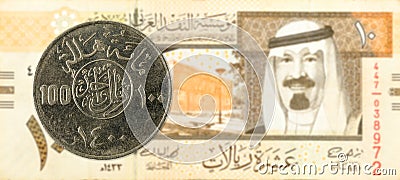 100 saudi riyal coin against 10 saudi riyal bank note Stock Photo