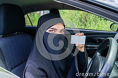 Saudi Woman Driving a Car on the road. Stock Photo