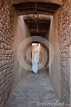 Saudian walking inside the walls of Al-Ula Old City, Saudi Arabia Stock Photo