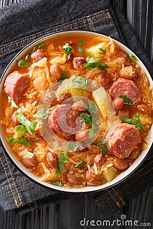 Sauerkraut and Bean Stew Slovenian Jota closeup in the plate. Vertical top view Stock Photo
