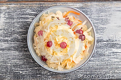 Sauerkraut, marinated cabbage on a gray wooden background. Top view, close up Stock Photo