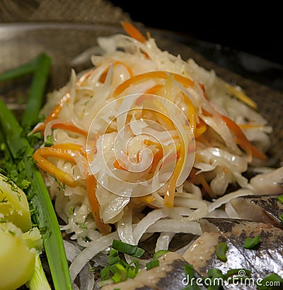 Sauerkraut with potatoes, fresh herbs and herring Stock Photo