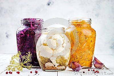 Sauerkraut variety preserving jars. Homemade red cabbage beetroot kraut, turmeric yellow kraut, marinated cauliflower and carrots Stock Photo