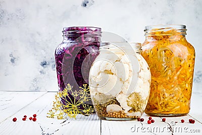 Sauerkraut variety preserving jars. Homemade red cabbage beetroot kraut, turmeric yellow kraut, marinated cauliflower pickles. Stock Photo