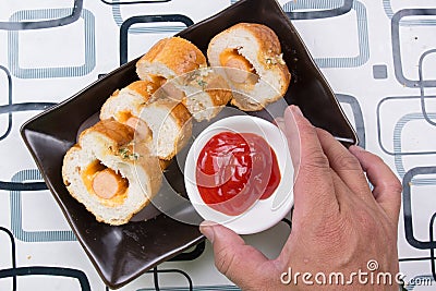 Sausage bread with ketchop Stock Photo
