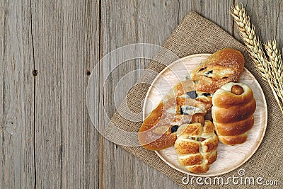 Sausage bread and wheat ears and sack on wooden background,top view Stock Photo