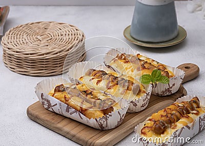 Sausage bread with yellow cheddar cheese, mayo and ketchup. Stock Photo