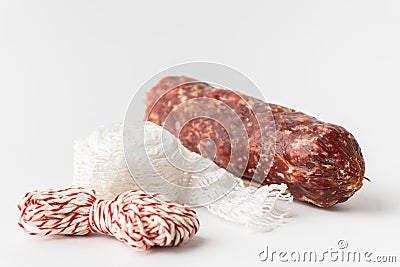 Sausage casing and cotton string roll for butchers. Elastic netting for roasting, boiling or smoking cold meat. Salami sausage on Stock Photo