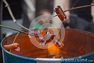 Sausage fire in barrel roasted Stock Photo