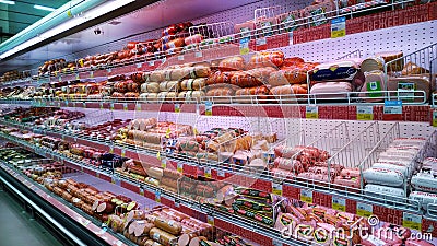 Sausage and lunch meat products on supermarket shelves. Retail industry. Concept of problem rising food price. Editorial Stock Photo