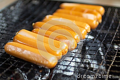 Sausage put on grill ,Fast food energy on morning. Image use for cook in the kitchen Stock Photo