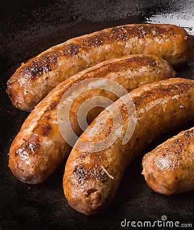 Sausages in a black frying pan Stock Photo