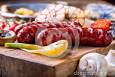 Sausages. Grill sausages. Grilled sausage with mushrooms garlic tomatoes and onions Stock Photo