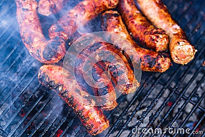 Sausages grilled on a charcoal barbeque. Top view of tasty barbecue, food concept, food on grill and detail of sausages on the Stock Photo