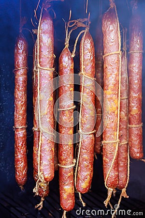 Meat hanging from a traditional smokehouse for smoking sausages. Stock Photo