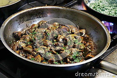 Saute mushrooms in a cooking pan Stock Photo