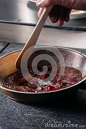 cherry sauce for poultry in a pan Stock Photo