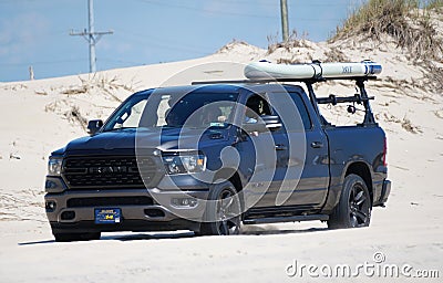 Savage Ditch, Delaware, U.S - July 4, 2023 - A black Dodge Ram pick up truck with a kayak and surf fishing beach permit driving on Editorial Stock Photo