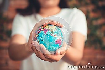 Save The Earth and Care Environment Concept, Close-up Portrait of Woman is Holding Mockup Global in Her Hands on Tree Leave Stock Photo
