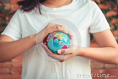 Save The Earth and Care Environment Concept, Close-up Portrait of Woman is Holding Mockup Global in Her Hands on Tree Leave Stock Photo
