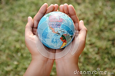 Save The Earth and Care Environment Concept, Close-up of Woman Hands is Holding Mockup Global Against on Tree Leave Background. Stock Photo