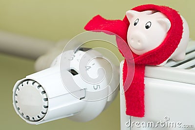 Save money heating concept with thermostat and piggy bank Stock Photo