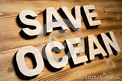 SAVE OCEAN words made with building blocks lying on wooden board Stock Photo