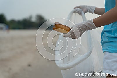 Save water. Volunteer pick up trash garbage at the beach and plastic bottles are difficult decompose prevent harm aquatic life. Stock Photo
