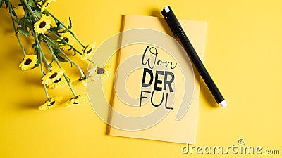 Save your ideas in notebook. Diary for your dreams or secret. Wonderful yellow notebook with black pan and small flowers Stock Photo