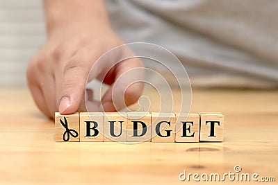 Saving on budget, text words typography written with wooden letter with scissor icon, life and business motivational inspirational Stock Photo