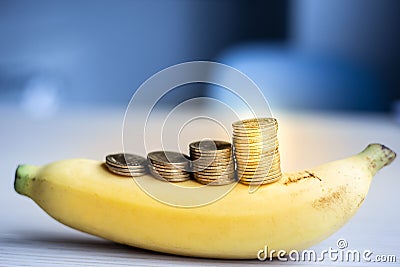 Money coins stack growing business on banana,Saving money concept Stock Photo