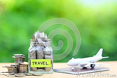 Saving planning for Travel budget of holiday concept,Financial,Stack of coins money in the glass bottle and airplane on passport Stock Photo