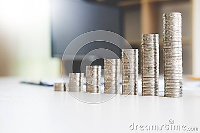 Saving stack coins money for growing your business concept,graph,chart document and pen on desktop desk in office copy space Stock Photo