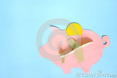 Saving for travel fund and vacation concept. Piggy bank with airplane model. Stock Photo